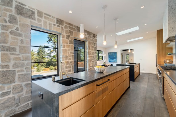 Modern kitchen with exposed stones.