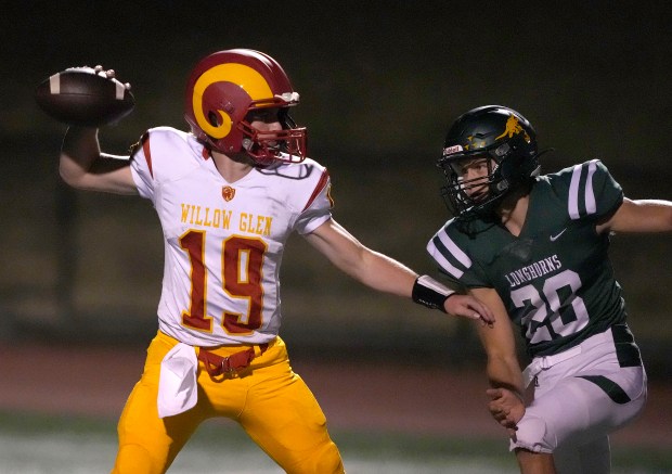Willow Glen's Cedeno Chavez (19) throws a pass under pressure from Leigh's Zach Pistor (20) in the first half in San Jose, Calif., on Friday, October 13, 2023. Tony Avelar for the Bay Area News Group