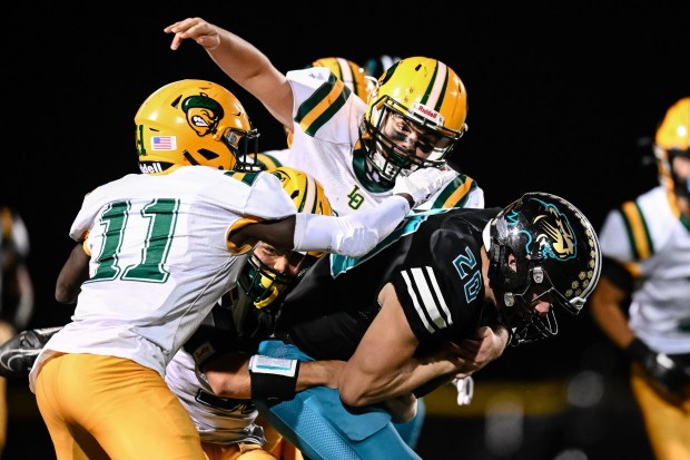 Live Oak defense brings down Christopher's Jaxen Robinson (20) during the 2nd half of the Live Oak vs Christopher BVAL high school football game at Christopher High School in Gilroy, Calif., on Friday, Nov. 3, 2022. (Thien-An Truong for Bay Area News Group)