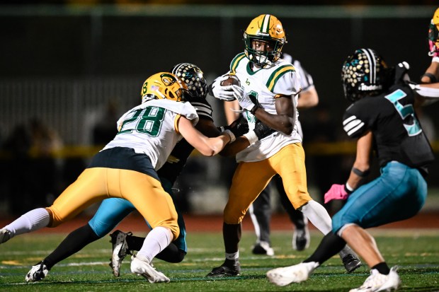 Live Oak's Christian Hauge(11) runs for yardage while being guarded during the 2nd half of the Live Oak vs Christopher BVAL high school football game at Christopher High School in Gilroy, Calif., on Friday, Nov. 3, 2022. (Thien-An Truong for Bay Area News Group)