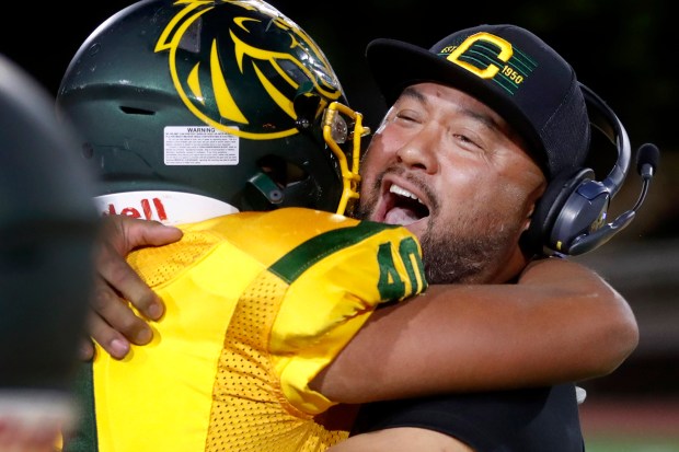 Capuchino head coach Jay Oca hugs his son Javon Oca after a thrilling 42-35 overtime victory against San Mateo, Friday, Oct. 13, 2023, in San Bruno, Calif. (Karl Mondon/Bay Area News Group)