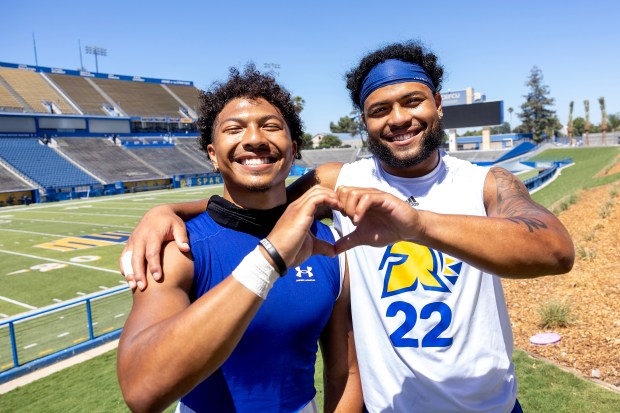 Twin brothers Andrew Jenkins (#27) and Tre Jenkins (#22), star defensive backs with the San Jose State football team, share the love after practice, Thursday, Aug. 10, 2023, in San Jose, Calif. (Karl Mondon/Bay Area News Group)