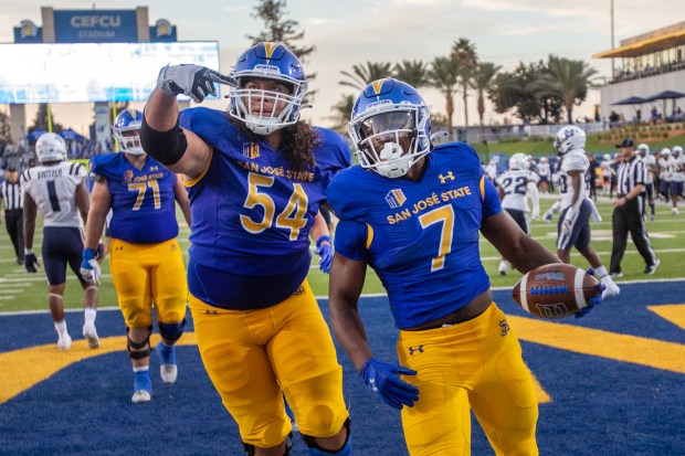 San Jose State's Jaime Navarro helps celebrates Quali Conley's (7) 3rd quarter touchdown that gives the Spartans the lead against Utah State in a Mountain West football game, Saturday, Oct. 21, 2023, in San Jose, Calif. (Karl Mondon/Bay Area News Group)