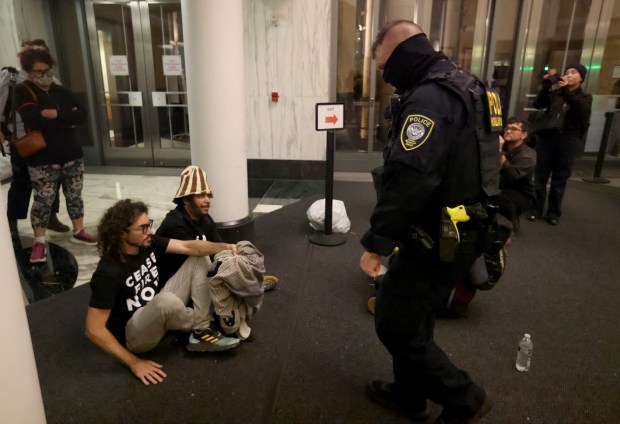 Local activist and filmmaker Boots Riley, second from left, and others are arrested by Federal Protective Service police as Jewish-led groups protest and call for a ceasefire in Gaza at the Ronald V. Dellums Federal Building in downtown Oakland, Calif., on Monday, Nov. 13, 2023. (Jane Tyska/Bay Area News Group)