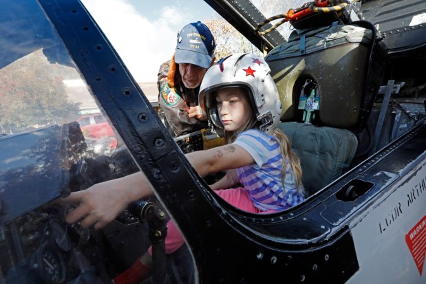 Vietnam veteran Willie Sharp explains all the controls to Grace Martin, 8, from Danville, in the cockpit of a F8 Crusader fighter aircraft during the Veteran's Day Open House at the Veteran's Memorial Building in Danville, Calif., on Friday, Nov. 10, 2017. The Veteran's Day Open House runs through the weekend with special displays commemorating the 75th anniversary of the Doolittle Raid, the war in the Philippines and the Bataan Death March. In addition, military memorabilia, archival films, and military vehicles will be on display with special speakers scheduled. (Laura A. Oda/Bay Area News Group)