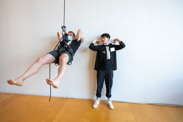 OAKLAND, CA - NOVEMBER 12: Becca Dean (right) instructs Dave Cox hanging from a rope attached to a harness during a flight test vertical dance lesson at the BANDALOOP open house at their studio space in Oakland, Calif. on Nov. 12, 2023. BANDALOOP is a renown vertical dance troupe, that have performed their aerial mid-air performances on international landmarks around the world. (Douglas Zimmerman/Special to the Bay Area News Group)