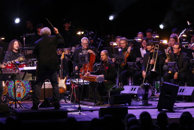 Bobby Weir & Wolf Bros featuring The Wolfpack with Barry Sless on pedal steel guitar, center, perform with the Stanford Symphony Orchestra led by conductor Paul Phillips at the Frost Amphitheater in Palo Alto, Calif., on Sunday, Oct. 29, 2023. (Jane Tyska/Bay Area News Group)