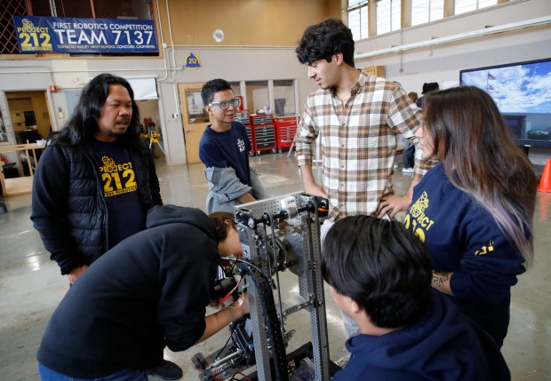 Teacher and advisor Joseph Alvarico, left, works with students in the robotics program at Ygnacio Valley High School in Concord, Calif., on Wednesday, Oct. 25, 2023. Alvarico is originally from the Philippines and just won a California Teacher of the Year award. (Jane Tyska/Bay Area News Group)