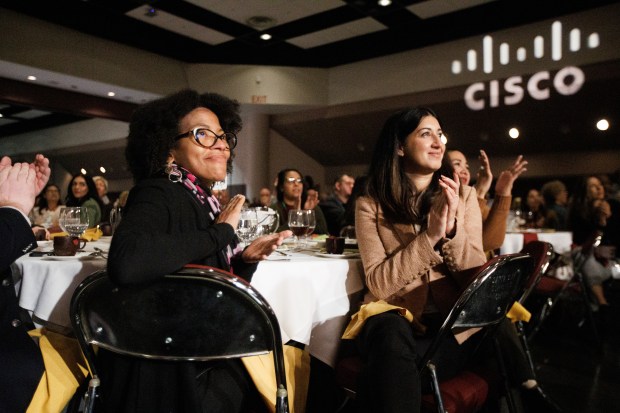 Attendees Maya Perkins, left, and Elle Parivar applaud at the YWCA Golden Gate Silicon Valley's Inspire Luncheon event on Thursday, Nov. 2, 2023, at Santa Clara Convention Center in Santa Clara, Calif. (Dai Sugano/Bay Area News Group)