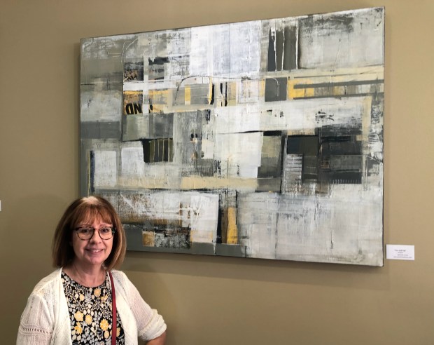 Mixed-media artist Belinda Lima stands in front of one of her paintings on display at the new Community Bank of the Bay branch on The Alameda in San Jose on Wednesday, Nov. 8, 2023. (Sal Pizarro/Bay Area News Group)