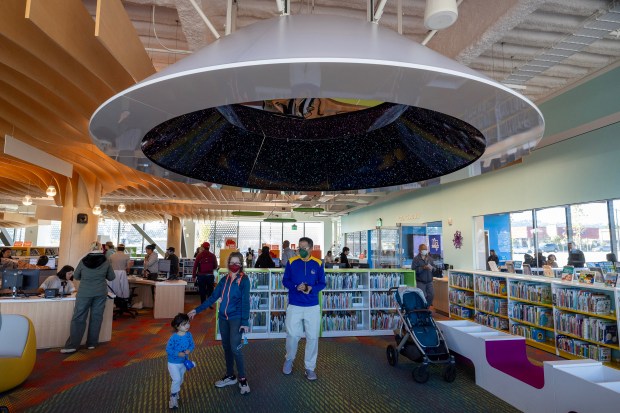 A young family investigates the children's section of the new Library and Parks and Recreation Center, Saturday, Oct. 28, 2023, after its grand opening in South San Francisco, Calif. (Karl Mondon/Bay Area News Group)