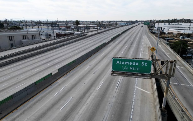 A portion of Interstate 10 in Los Angeles, between Alameda Street and Santa Fe Avenue is empty on Monday, Nov. 13, 2023. Los Angeles will be without a section of a vital freeway that carries more than 300,000 vehicles daily for an uncertain amount of time following a massive weekend fire at a storage yard, officials warned Monday. (Dean Musgrove/The Orange County Register via AP)
